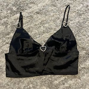 Black crop top, adjustable straps. Zipper on back.